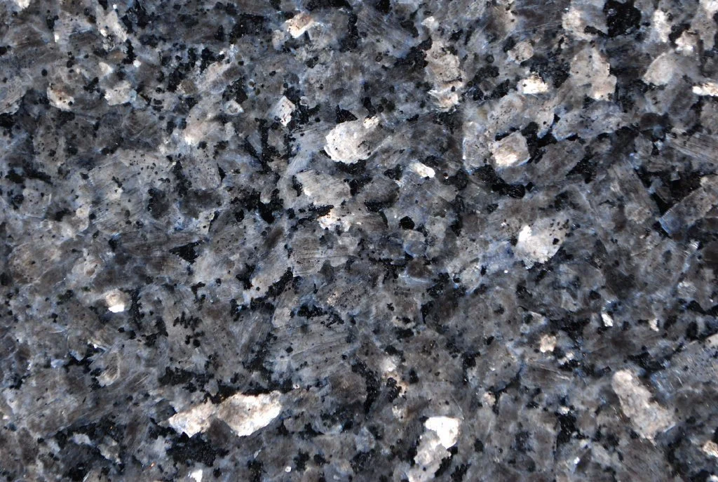 Close-up of a granite countertop surface with a pattern of black, gray, and white specks.