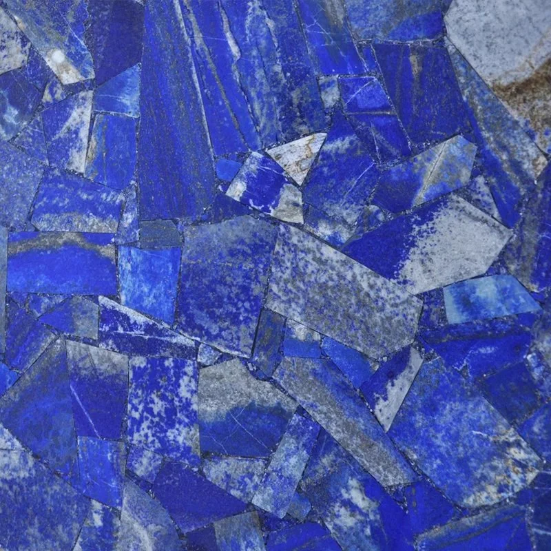Close-up of a mosaic made of irregular blue and gray stone tiles.