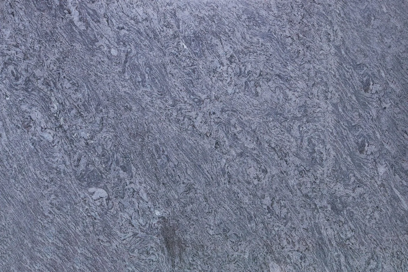 Close-up view of a textured gray stone surface with intricate veining.
