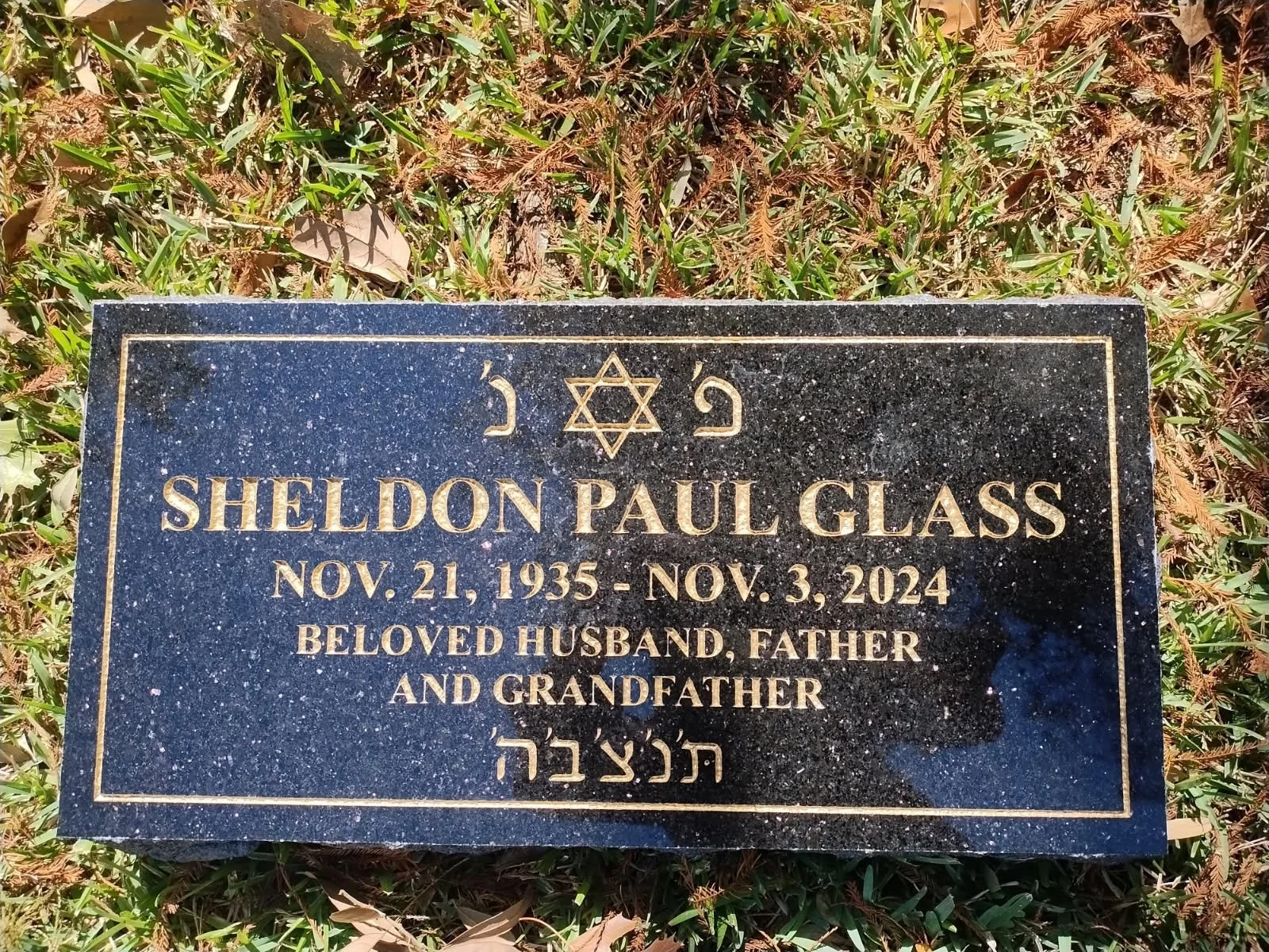 Gravestone for Sheldon Paul Glass, with Star of David, inscribed with birth date November 21, 1935, and death date November 3, 2024, noting him as a beloved husband, father, and grandfather.
