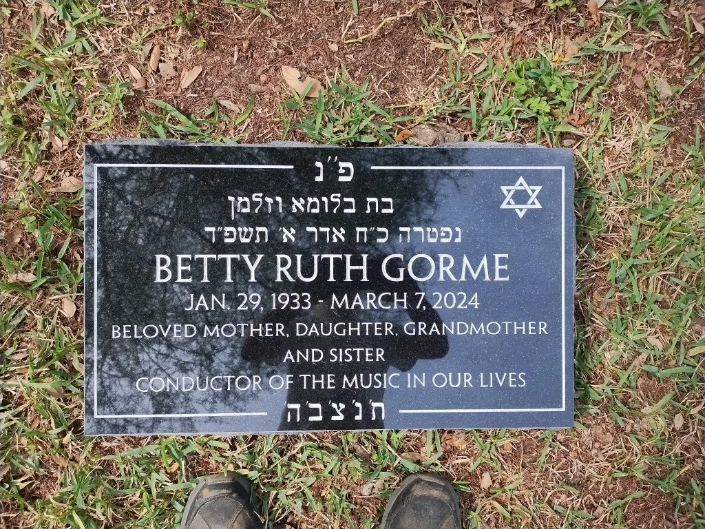 Gravestone memorial for Betty Ruth Gorme with Hebrew and English inscriptions, dating from January 29, 1933 to March 7, 2024, surrounded by grass.