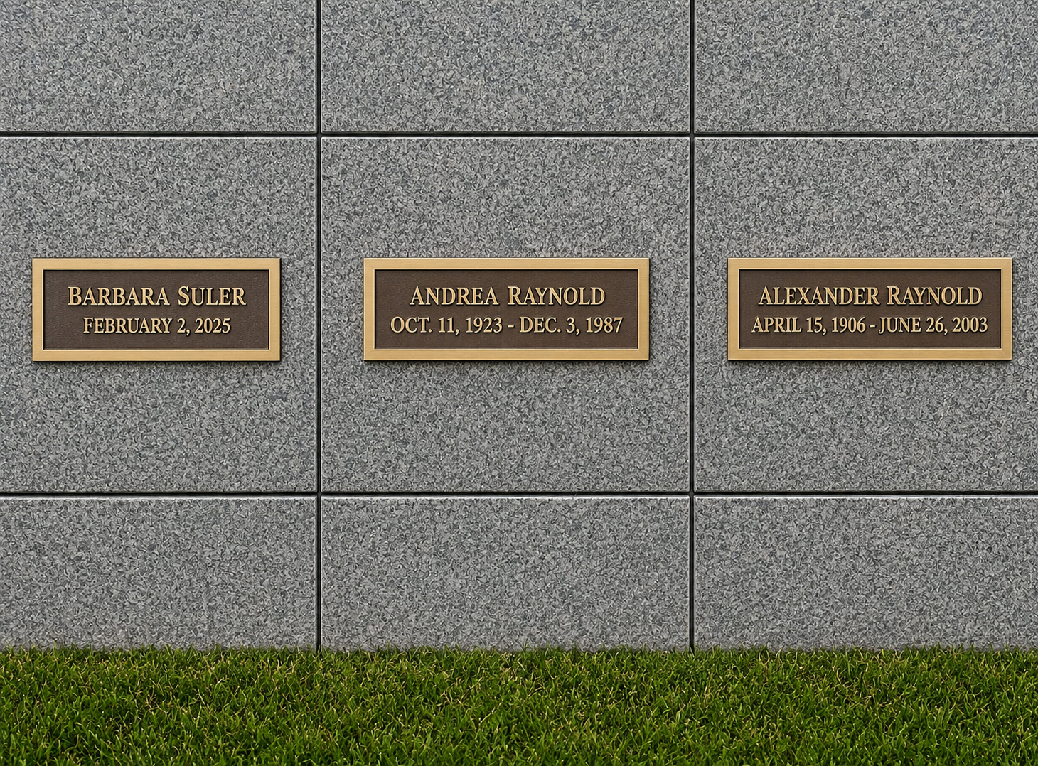 Memorial wall with three bronze plaques on gray stone, honoring Barbara Suler, Andrea Raymond, and Alexander Raymond, with their birth and death dates.
