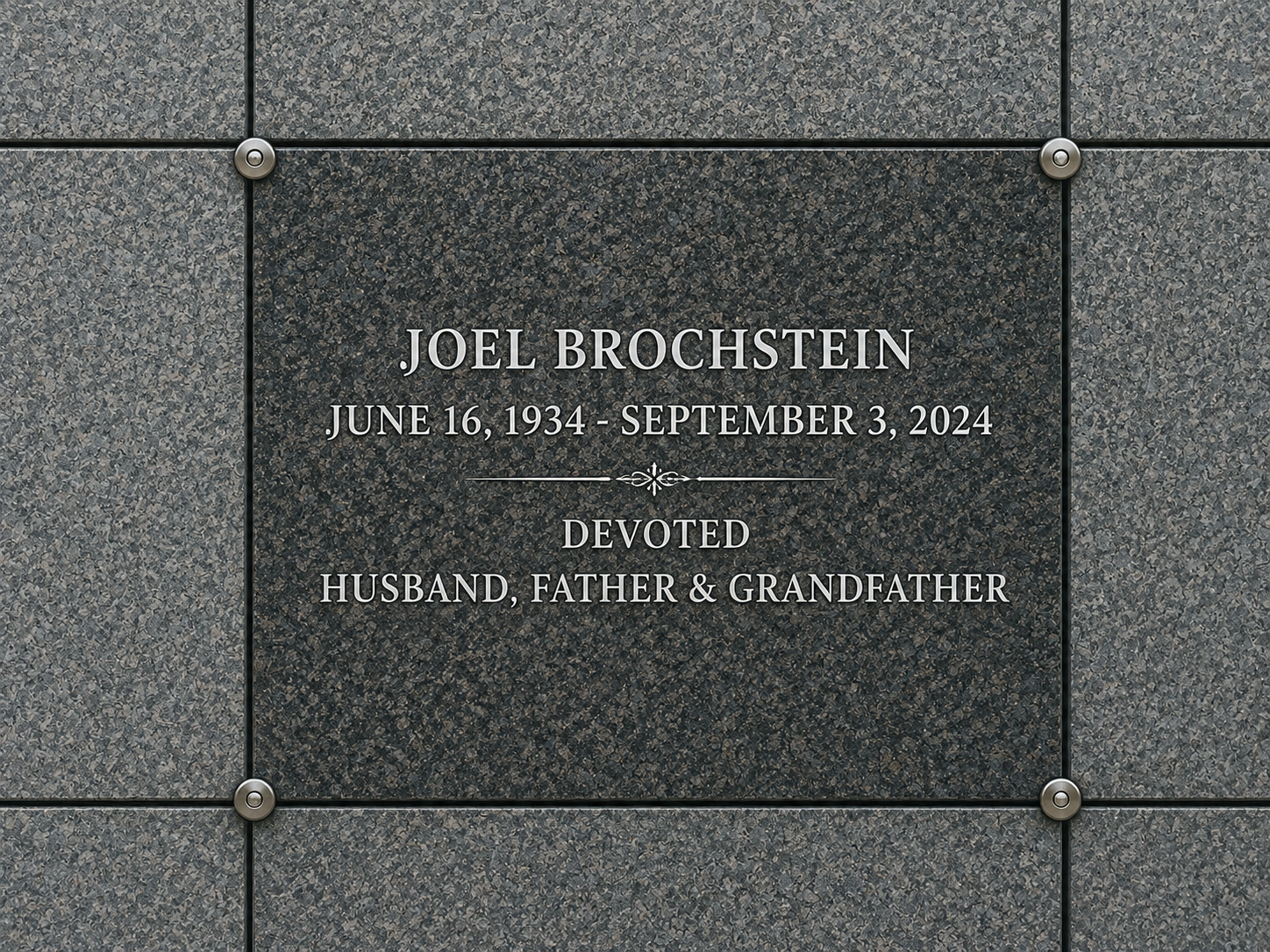 Gravestone inscription with the name Joel Brochstein, born June 16, 1934, died September 3, 2024, dedication to husband, father, and grandfather.