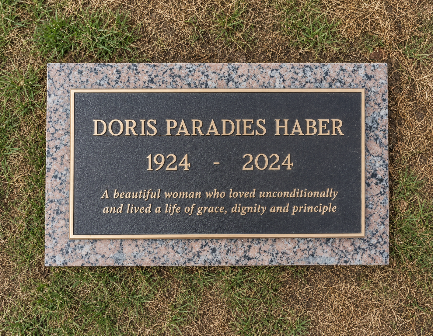 Gravestone for Doris Paradies Haber, with the years 1924-2024, surrounded by grass.