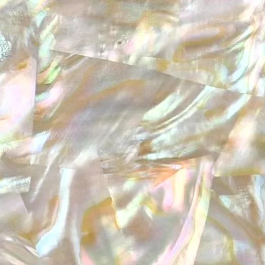 Close-up of iridescent, iridescent Mother of Pearl nacre with a swirling, reflective surface.