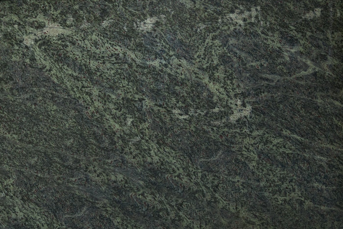 Close-up of a textured dark green and black patterned granite surface.