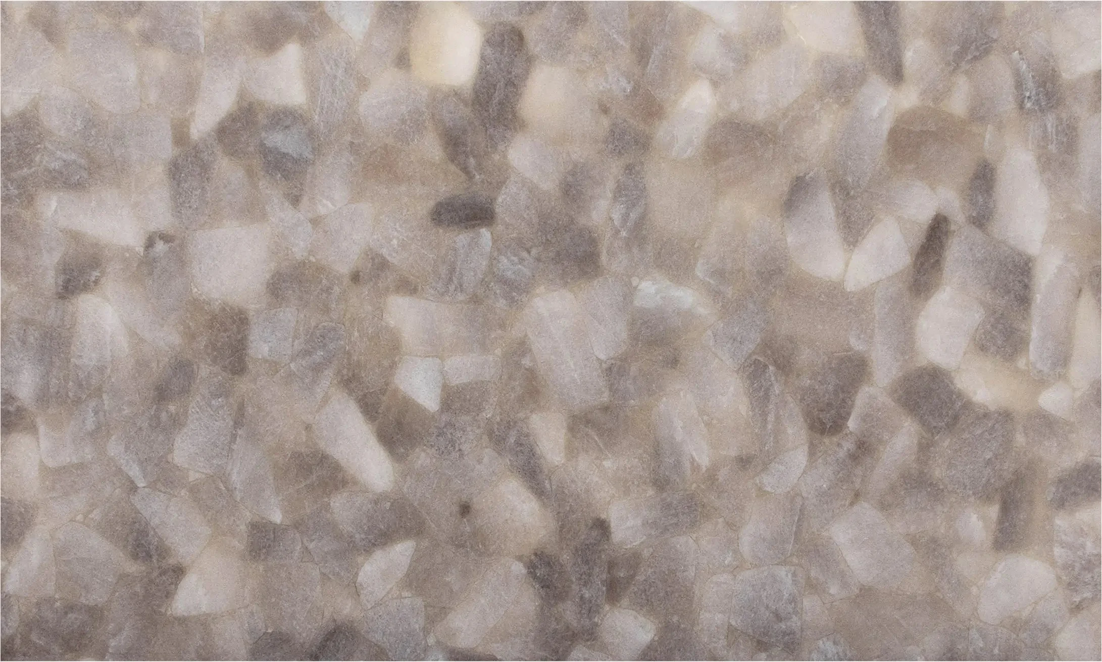 Close-up view of a floor made of beige and brown small pebble tiles.