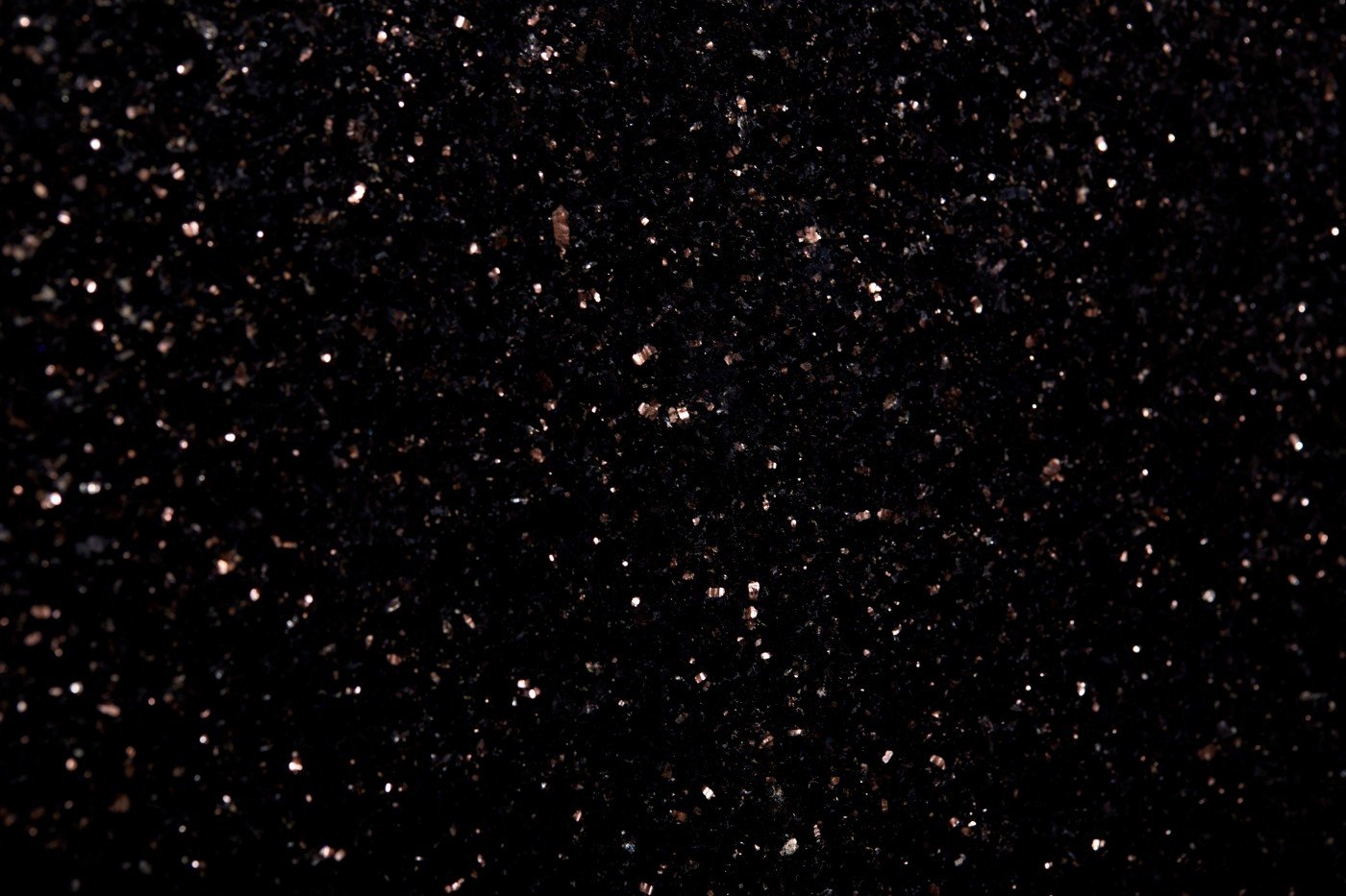 Close-up of black glitter with reflective particles