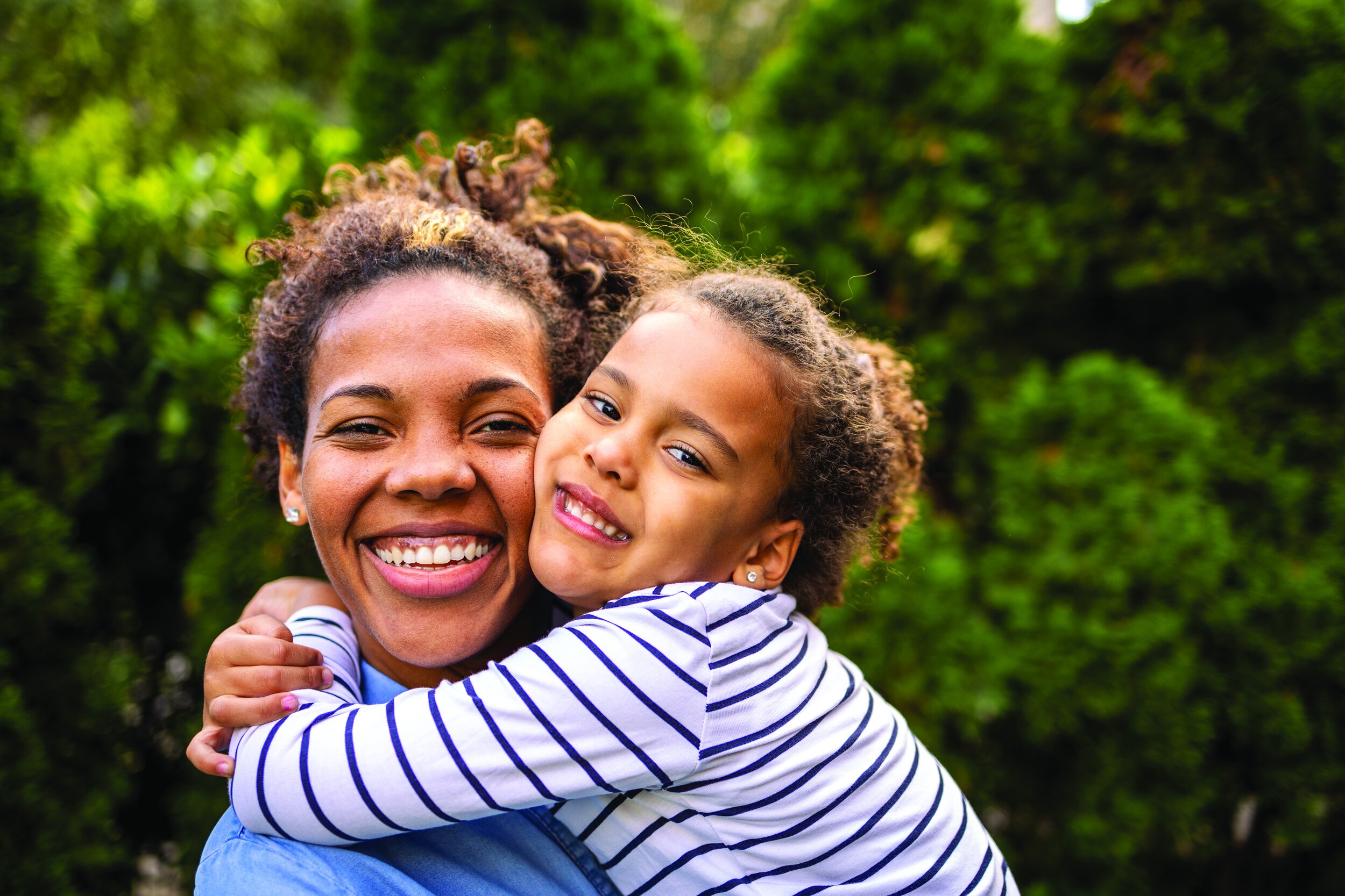woman and child smiling and hugging