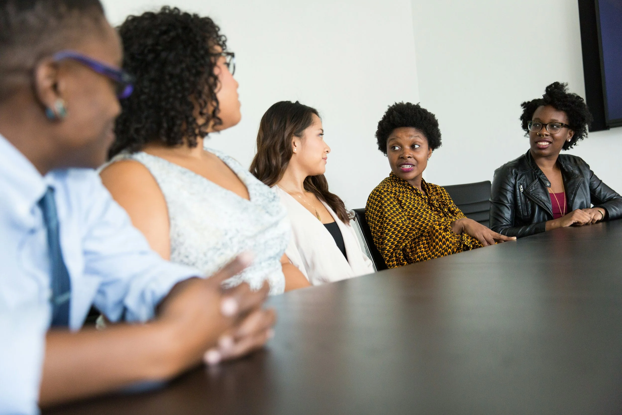 people in a meeting in a closed environment