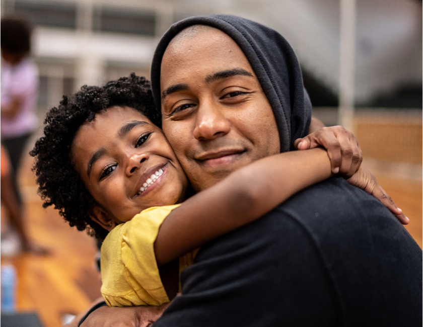 man and kid hugging