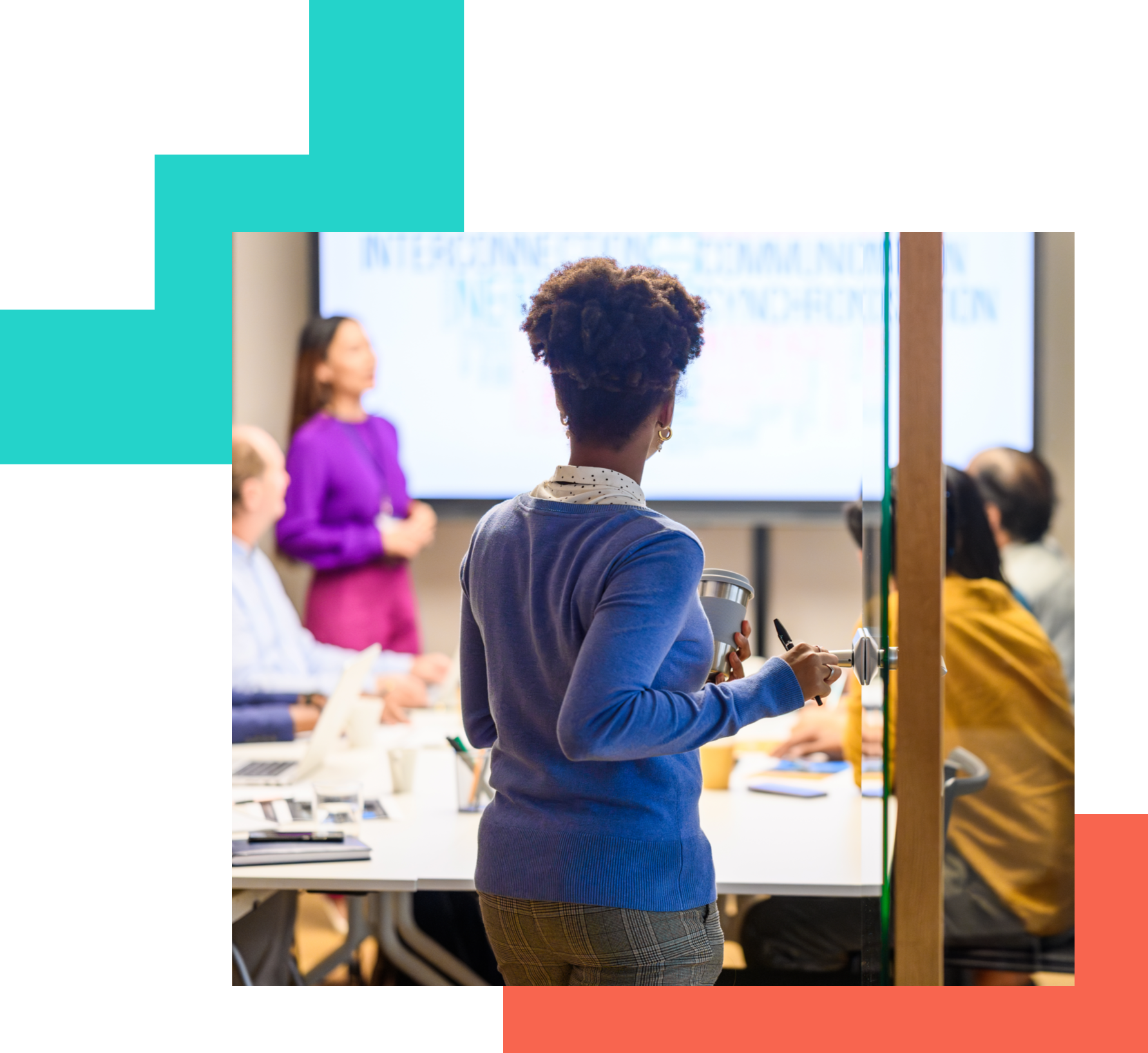 people in meeting with a big screen