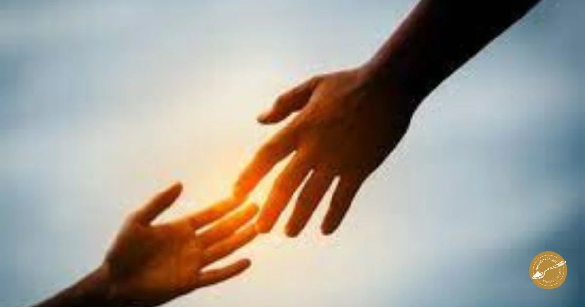 Two hands reaching toward each other in warm light