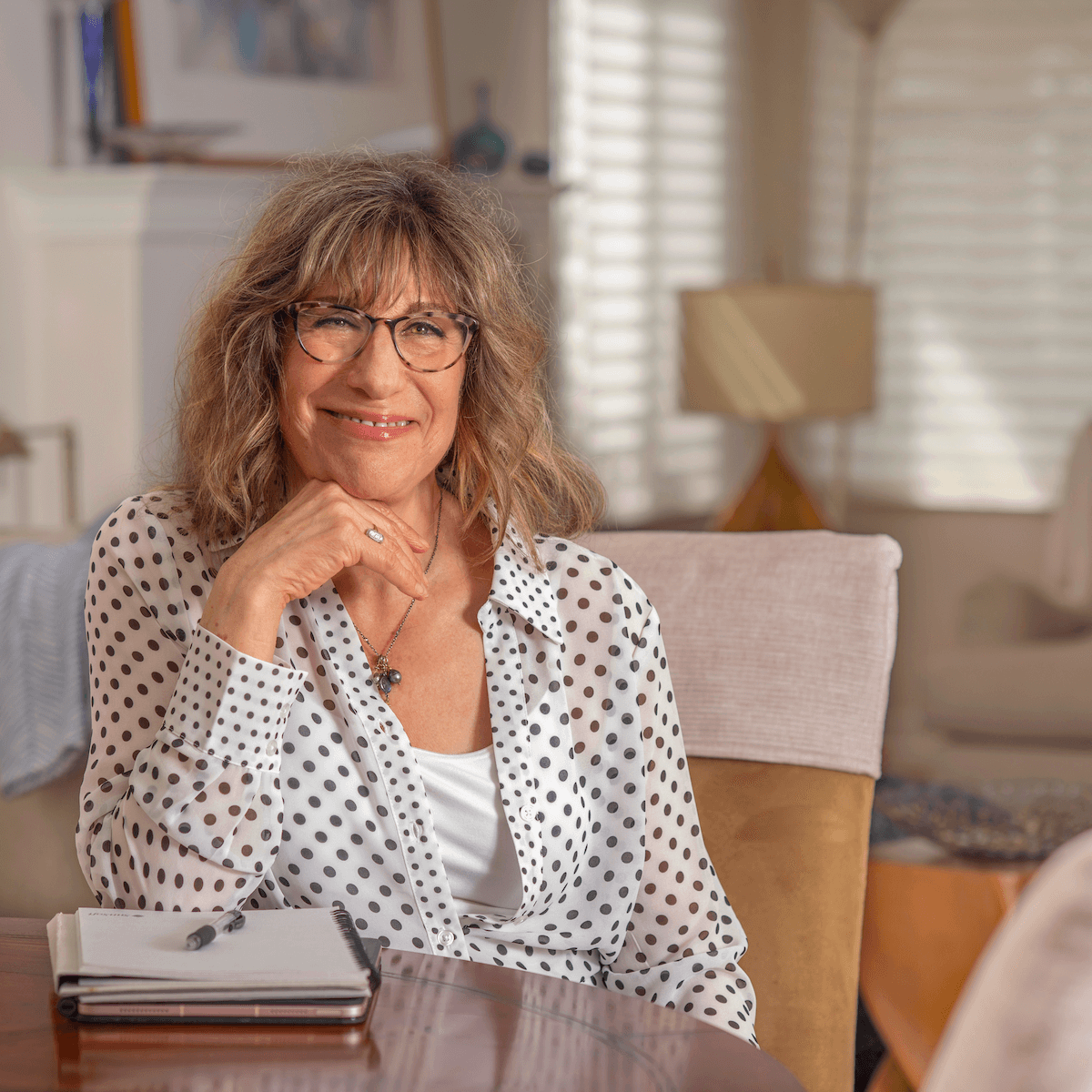 Andrea Nelson, licensed therapist in Los Altos, smiling warmly during a session in her therapy office