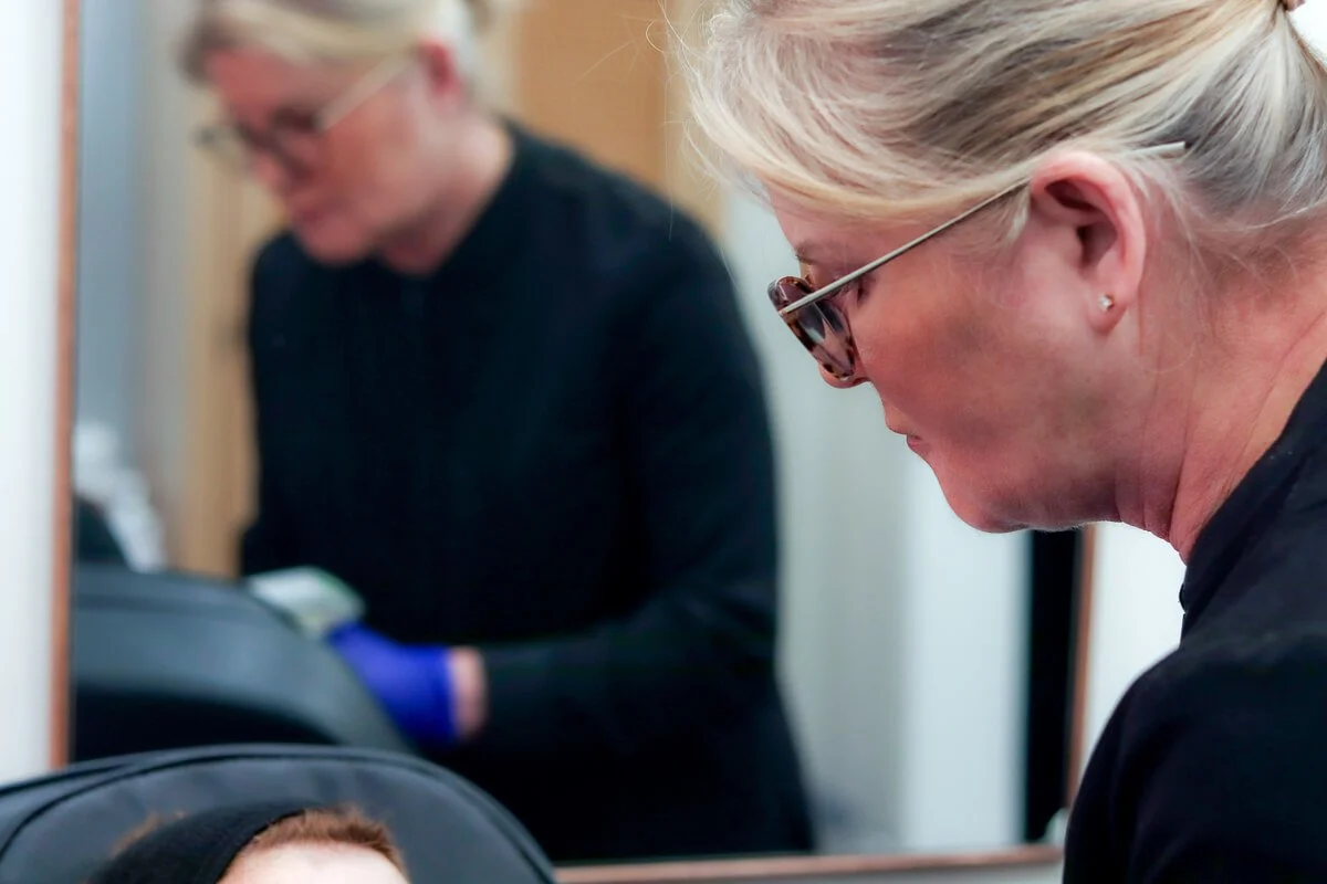 Susie giveing a client a laser skin treatment