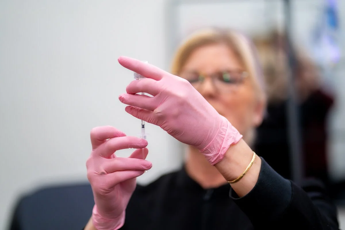 susie drawing up an injectable treatment with gloves on