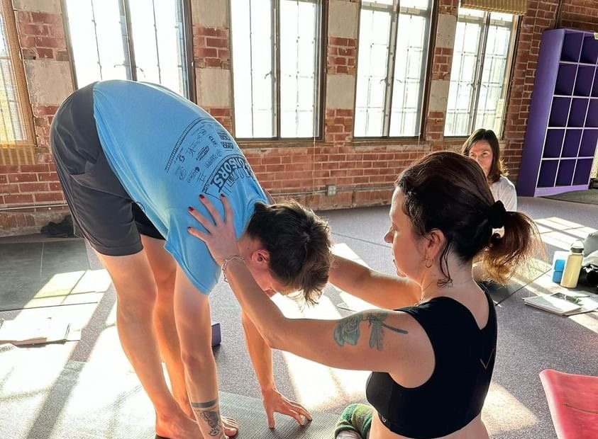 The Art of Hands-On Adjustments in Yoga: Cultivating Safety, Energy, and Connection
