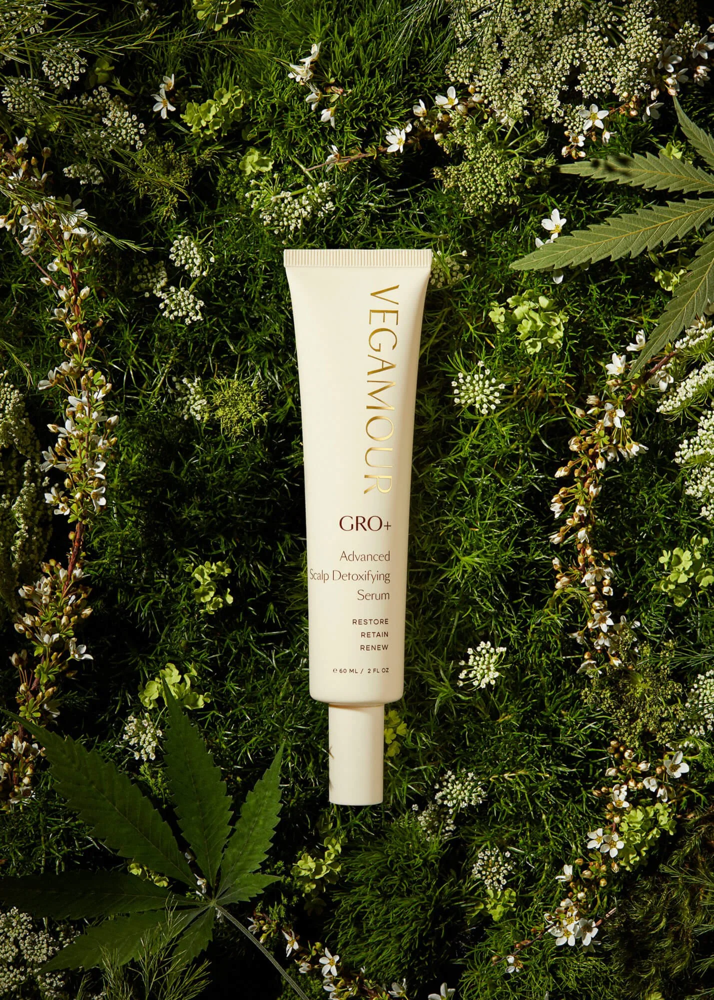 VEGAMOUR GRO+ Advanced Scalp Detoxifying Serum tube on green foliage background