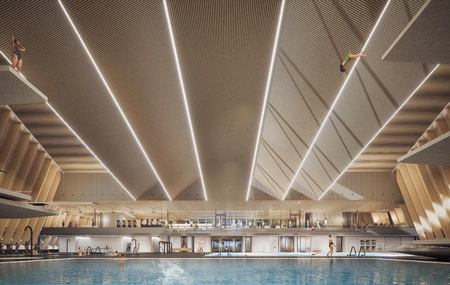 Interior view of a modern indoor swimming pool with a high, geometrically shaped ceiling featuring bright linear lighting. There are people swimming and relaxing around the pool, with a second level overlooking the pool area and gym equipment visible in the background.