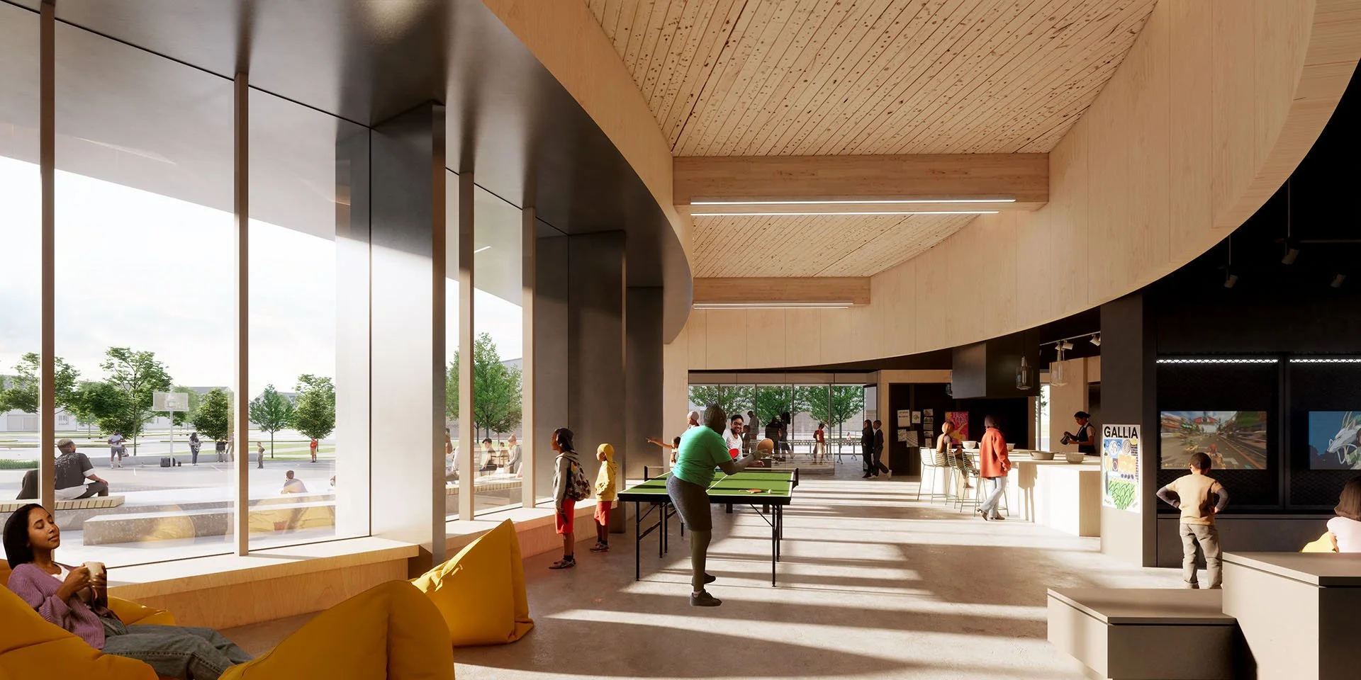 Interior of a modern community space with large windows, a ping pong table, seating area with yellow cushions, and people playing and socializing.