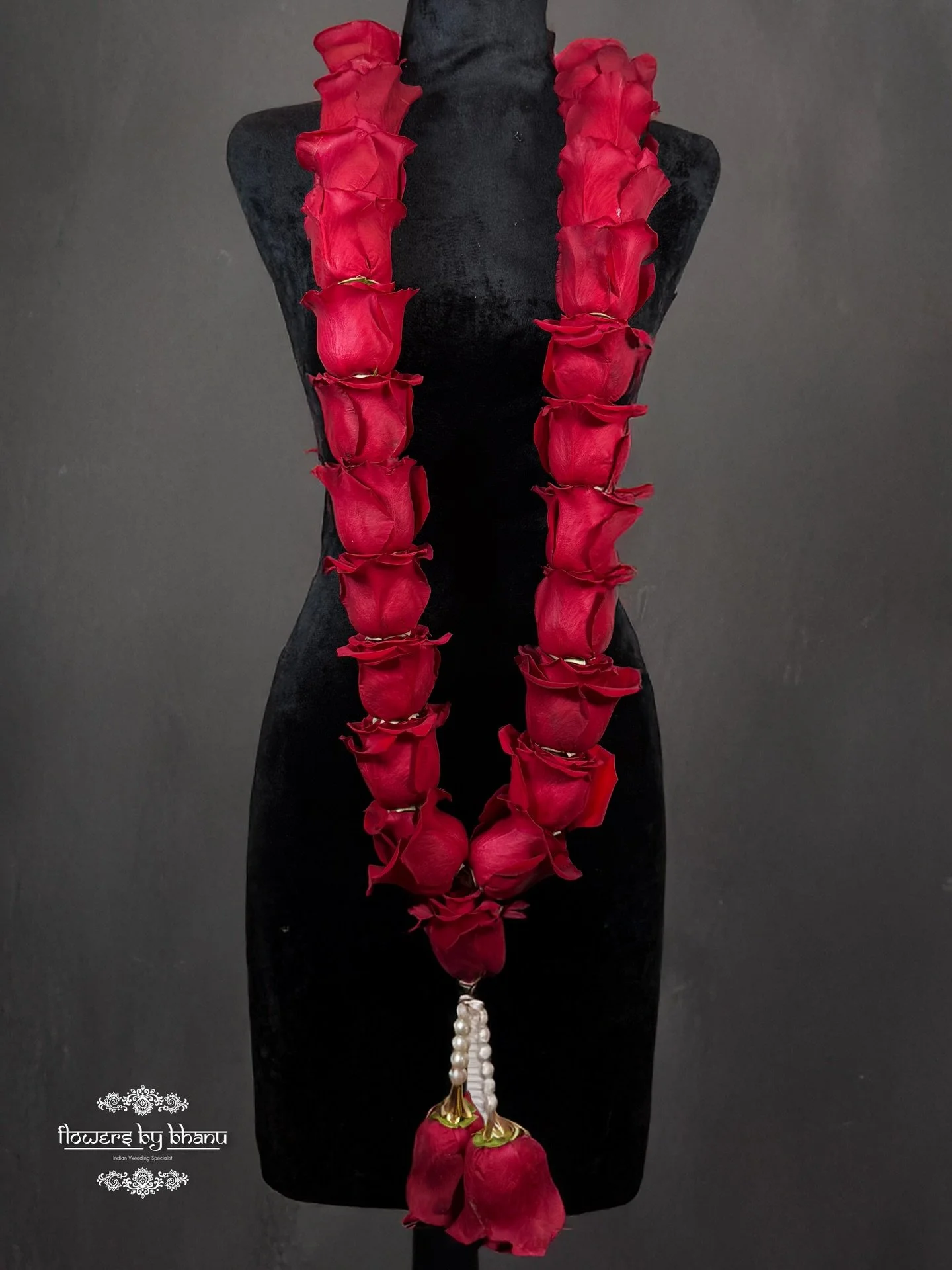 Handcrafted with deep red roses, finished with pearl detailing &mdash; pure wedding elegance.