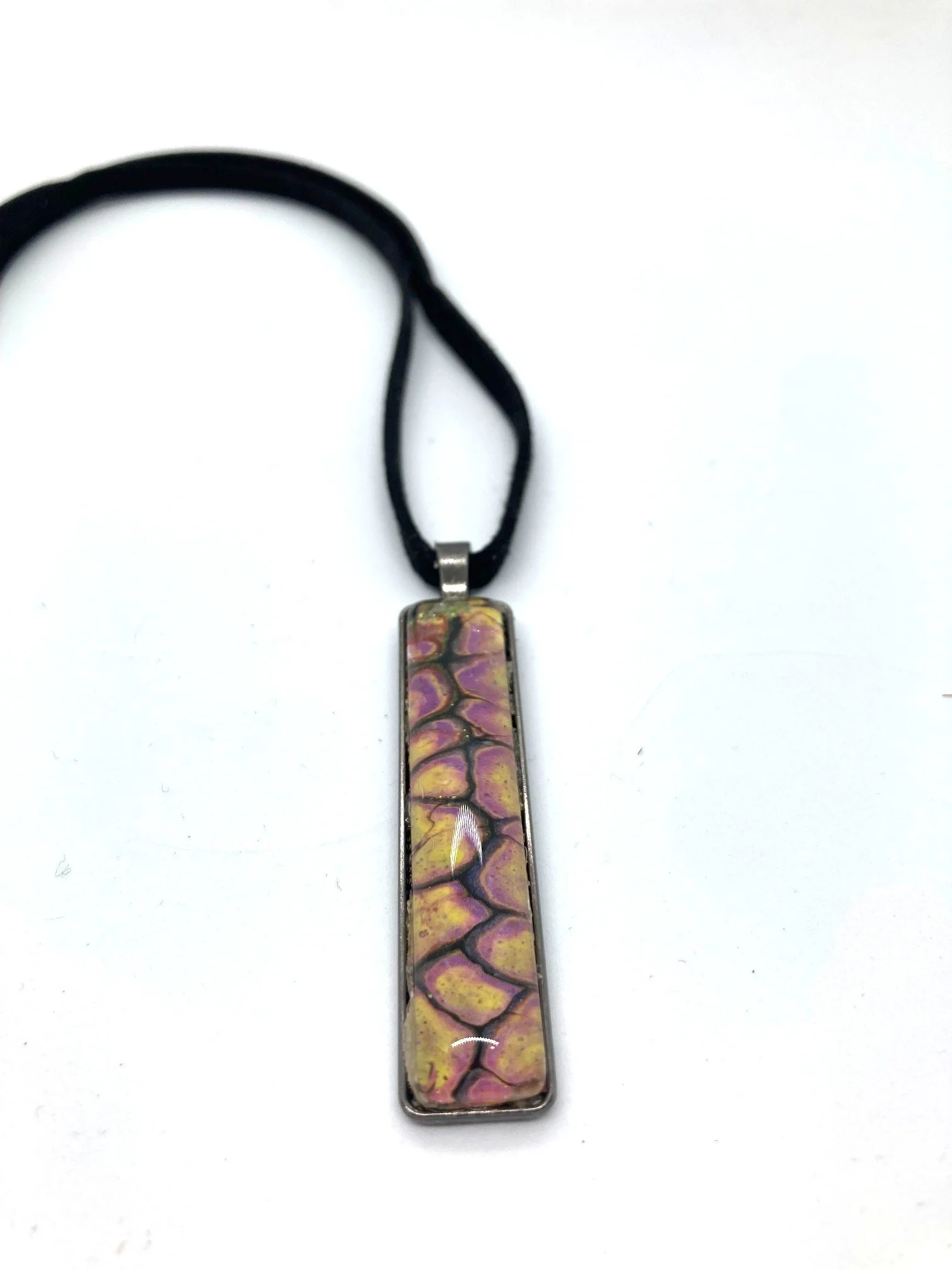 AcrylicPourNecklace_RectangleBezel_YellowndBlackChasmWithPink_LaidOut.jpg