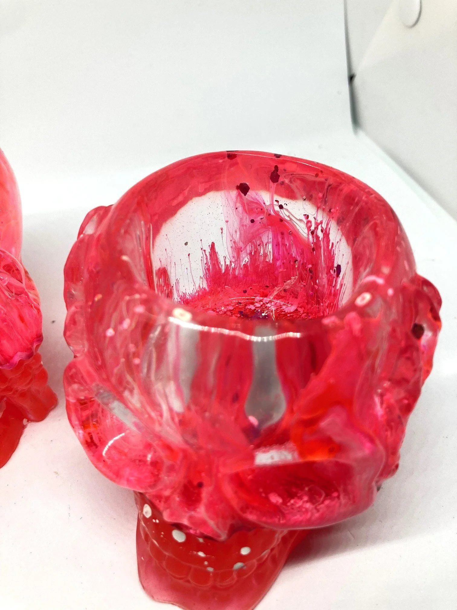 Large Resin Votives_HearNoEvilSkulls_PinkAndGlowinDark_CloseUpOfPetriColors3.jpg