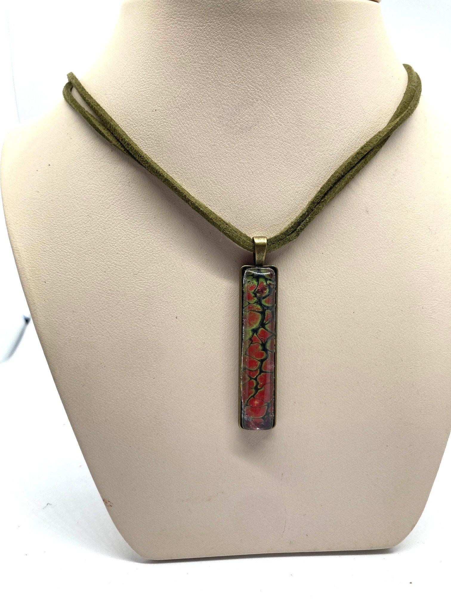 AcrylicPourNecklace_RectangleBezel_GreenandRedChasm_KhakiCord.jpg