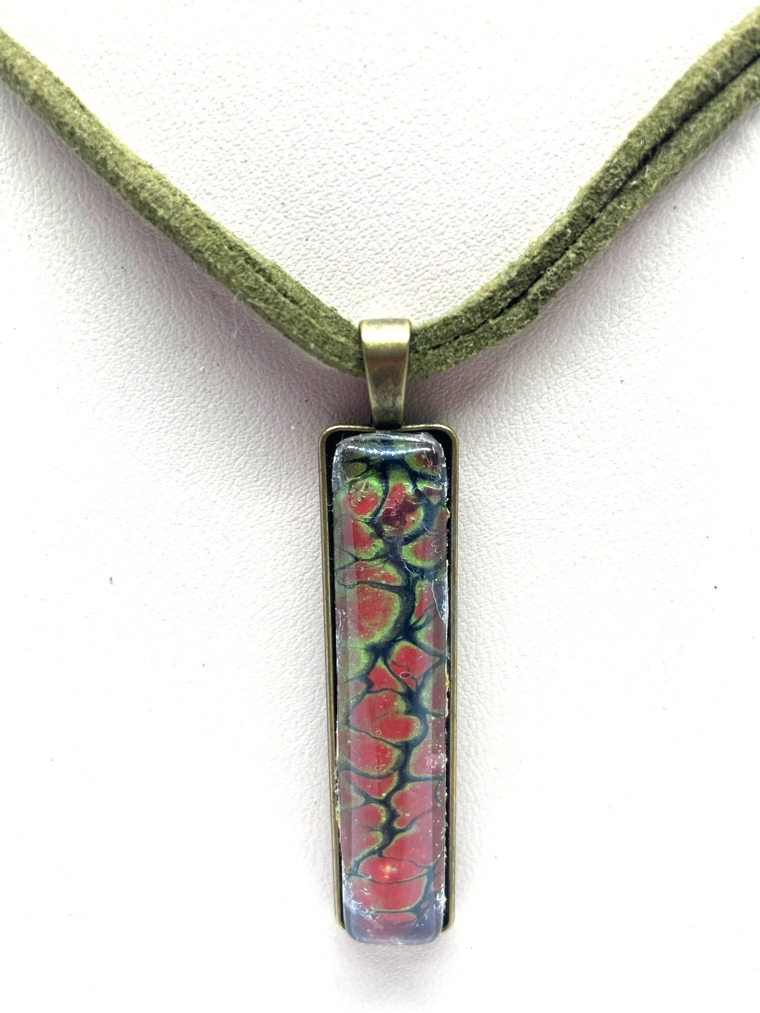 AcrylicPourNecklace_RectangleBezel_GreenandRedChasm_KhakiCord_CloseUp.jpg