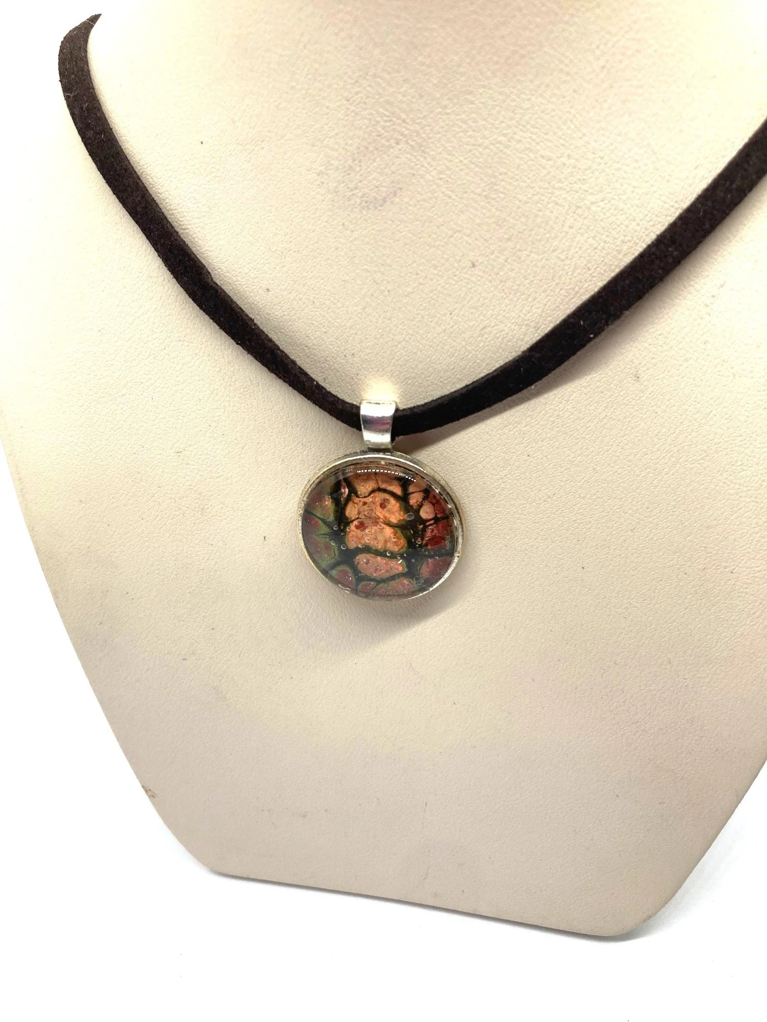 Acrylic Pour Necklace - "Peach, Green, and Red Chasm" Round alloy Bezel with a Black Cord