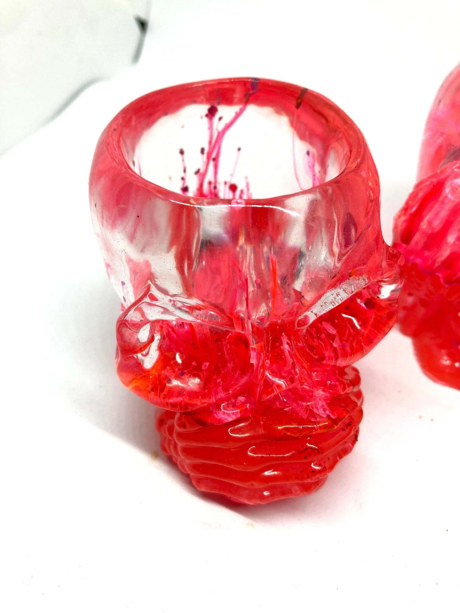 Large Resin Votives_HearNoEvilSkulls_PinkAndGlowinDark_CloseUpOfPetriColors.jpg