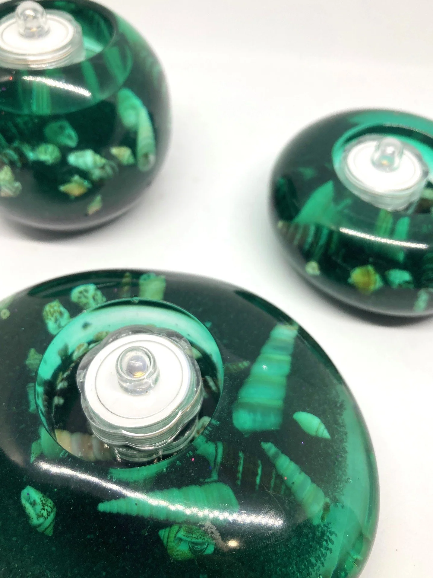 Large Resin Votive_Polished Stones_BlackSand_TurquoiseWithSeaShells_CloseUpTopViewWithLED.jpg