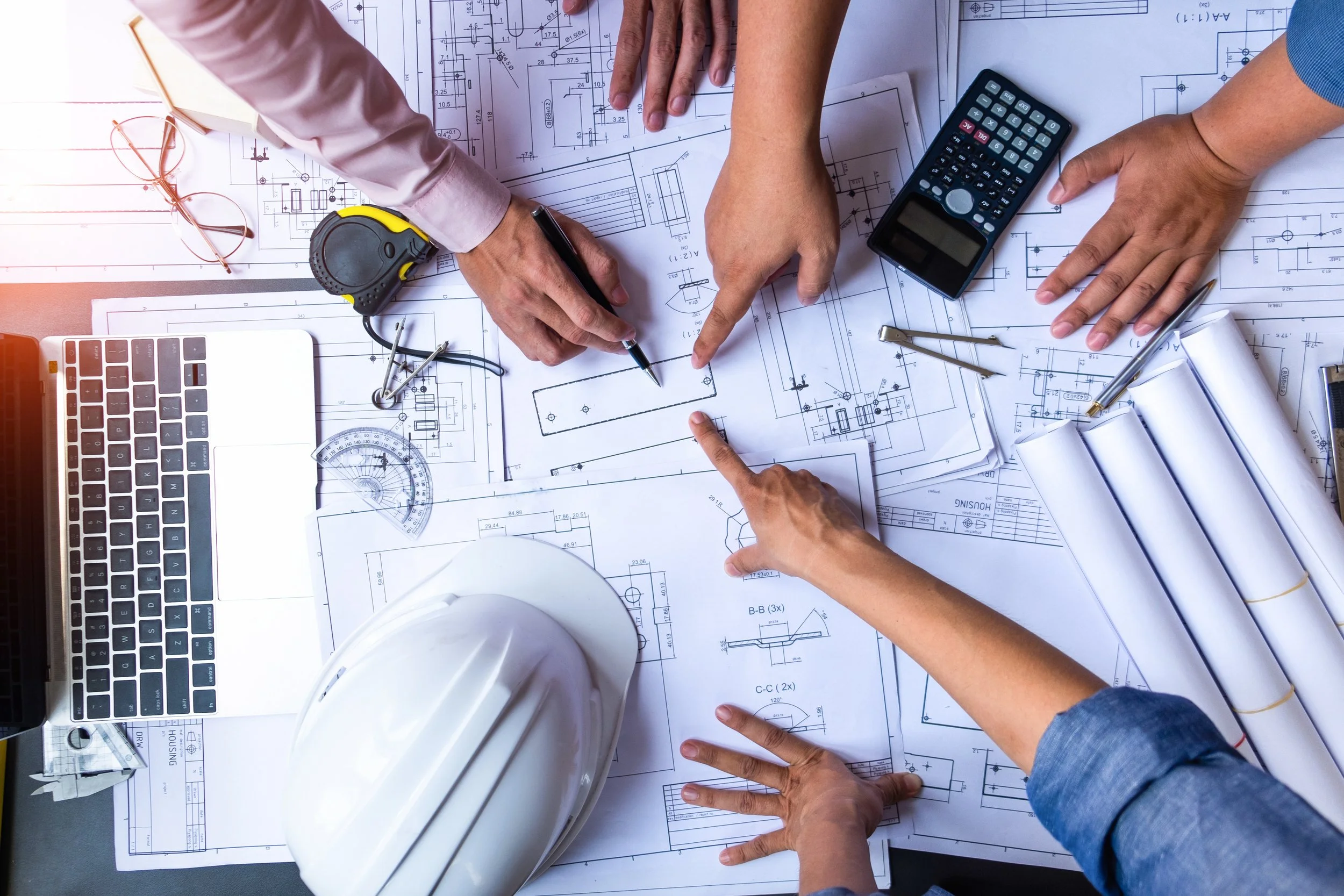 Design and construction team reviewing plans together