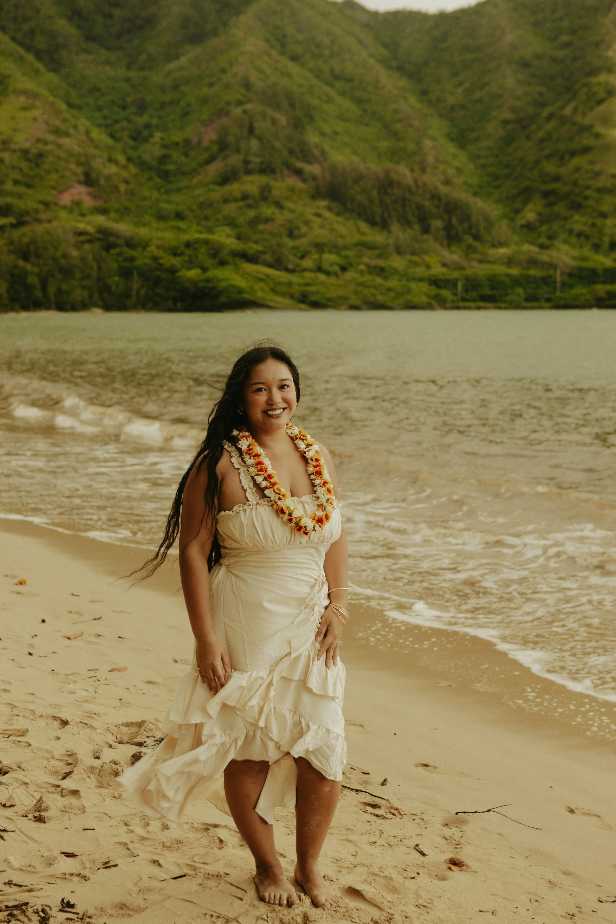 Kaila Ladrillono Laxa, therapist and founder of Transcmend, smiling on a beach in Hawaiʻi.