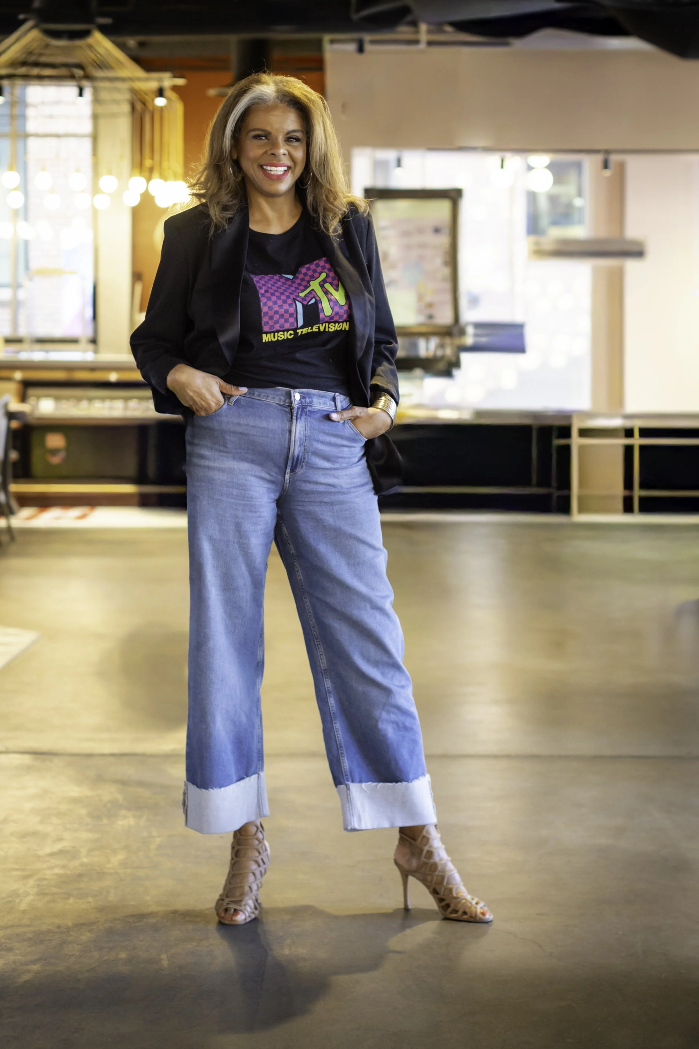 barbara brooks smiling standing tall in an 80s MTV graphic tee shirt