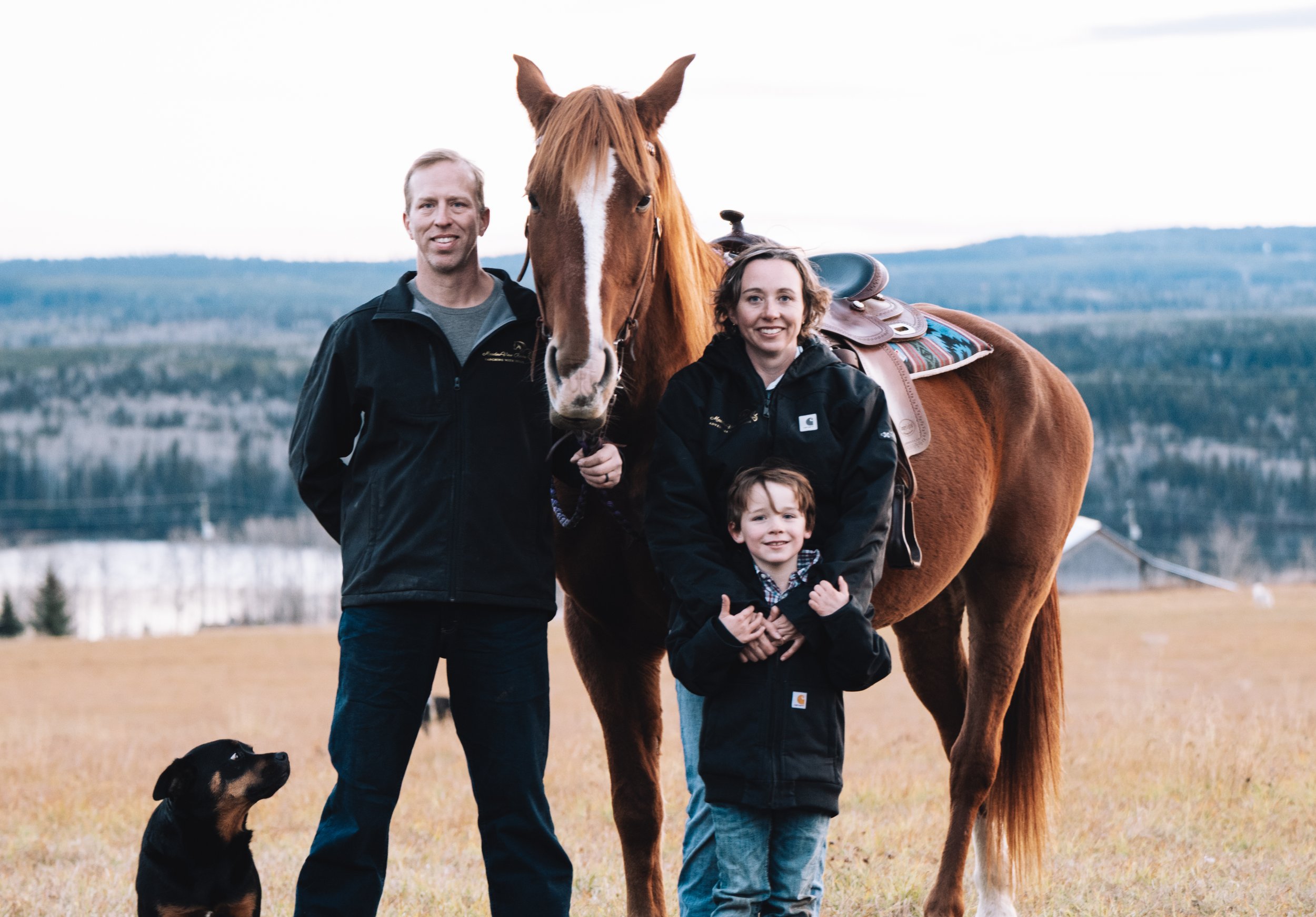 Guided horseback trail ride through the Cariboo wilderness near Big Lake, BC.