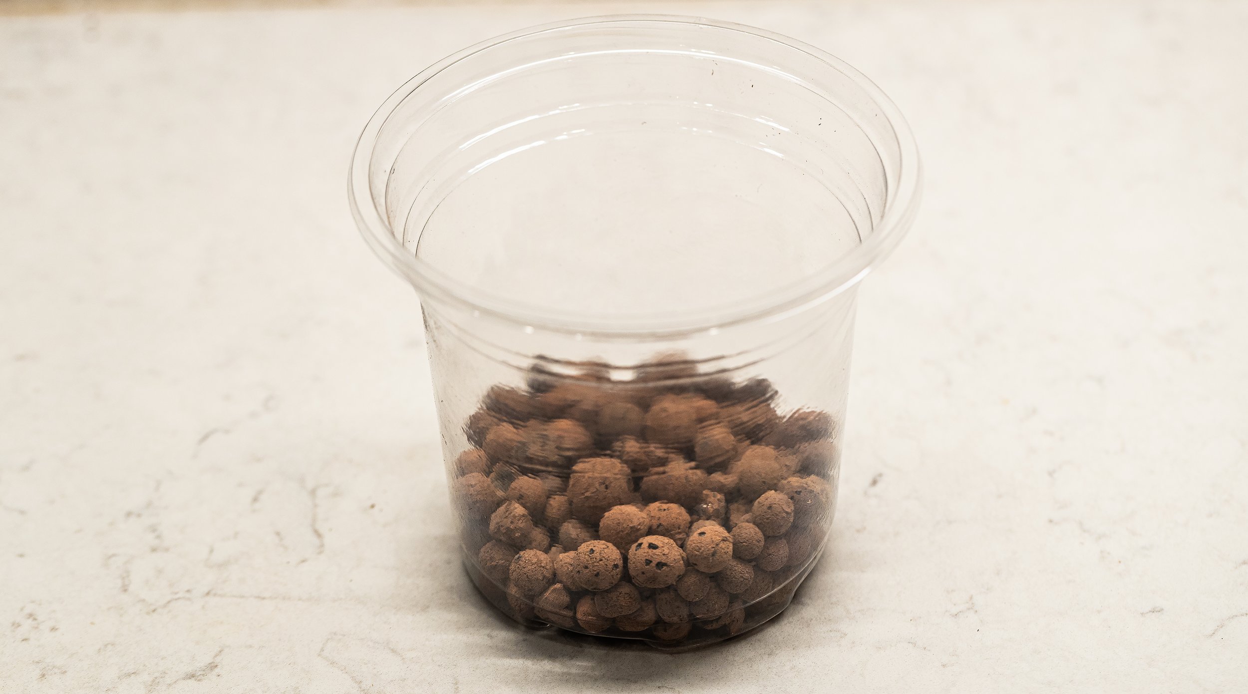 I use clear pots the size of the pot it’s in or one size larger, with several drainage holes. Put about a 1/2” layer of LECA as a drainage layer in the pot.