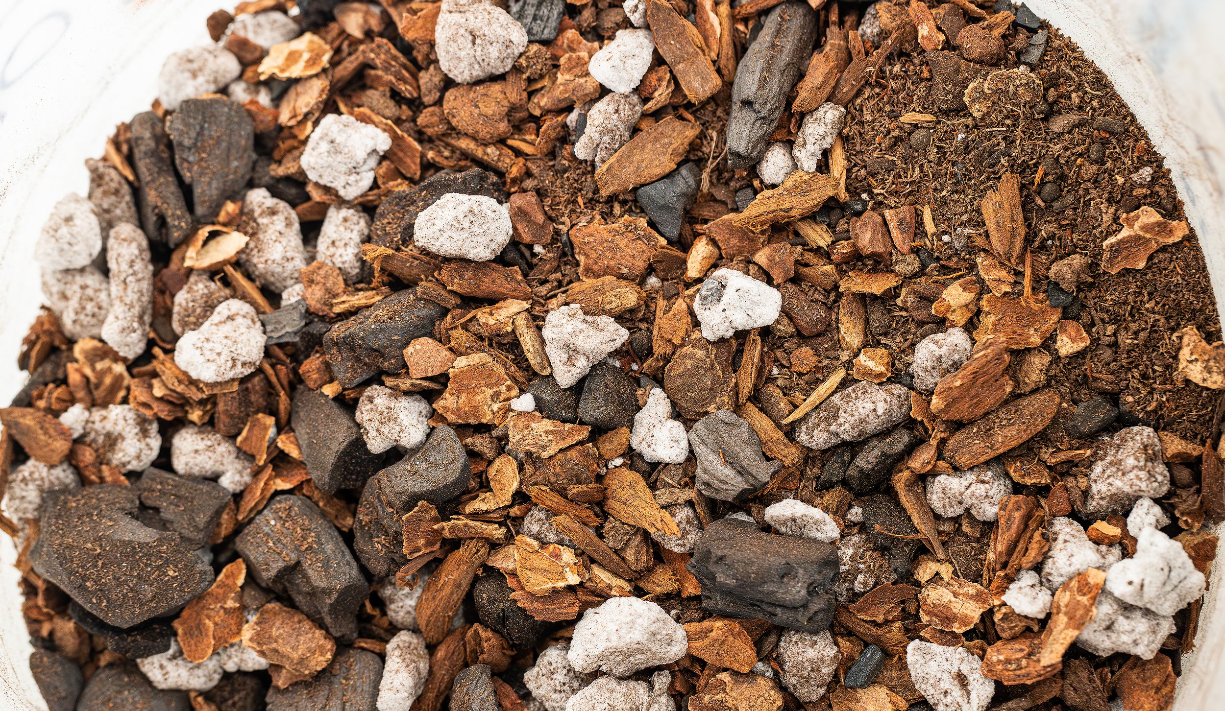 Now mix up some soil for the new plant by hand. For most plants, I do 1 part peat moss, 1 part orchid bark, 1/2-1 part horticultural charcoal, 1/2 part milled sphagnum moss, 1/2 part aqua soil, and 1/2 to 1 part perlite. For some of my aroids, I do