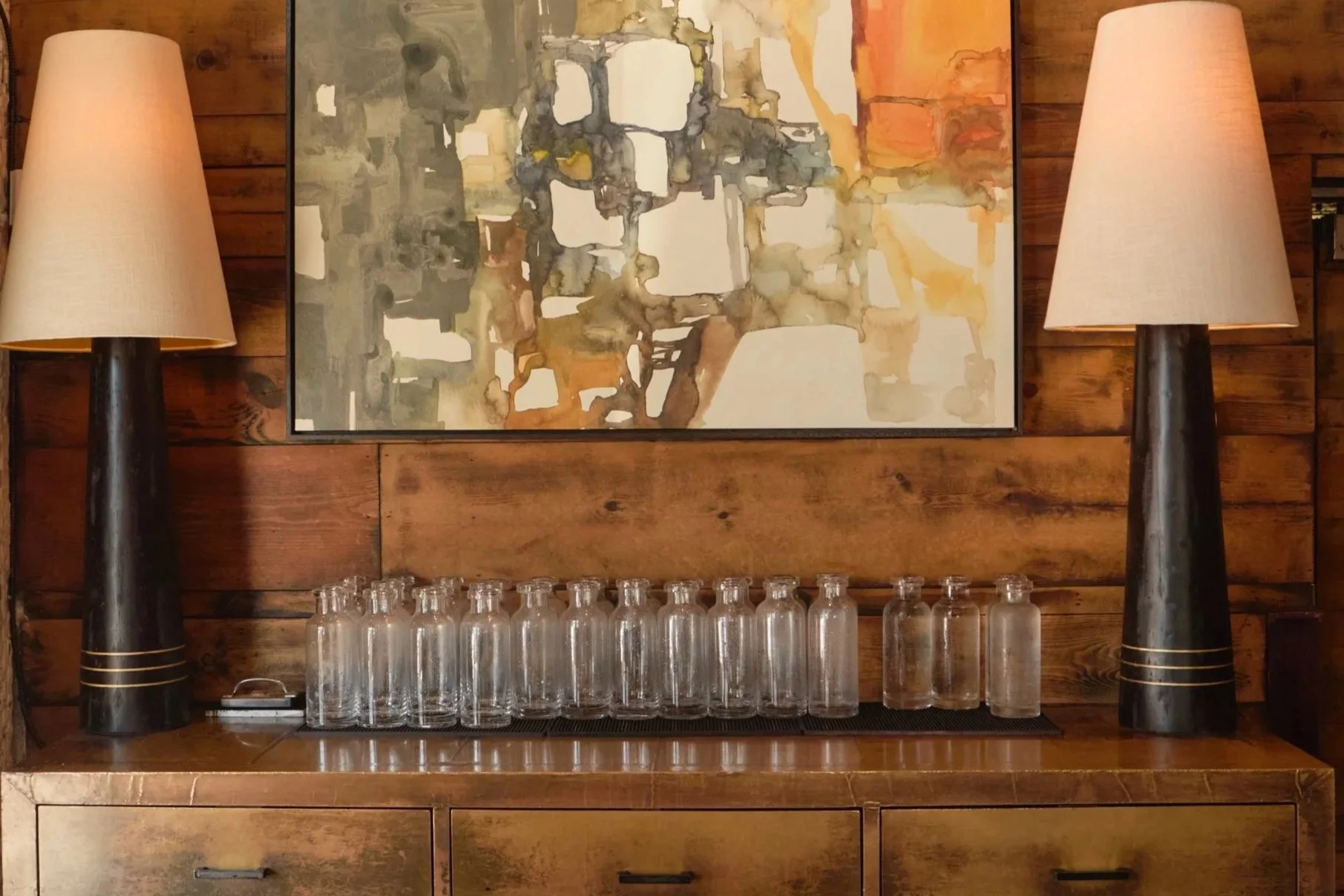 Interior of South Village Grille with modern artwork, warm wood tones, and glassware setup for a private dining event in German Village.