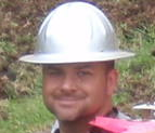 Child wearing a white construction helmet outdoors