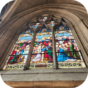 Stained glass window depicting biblical scene in cathedral