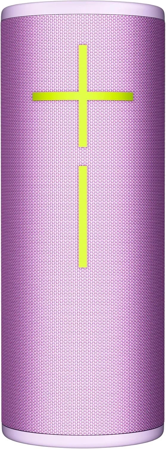 A close-up view of a pink portable speaker with a yellow cross symbol on its front.