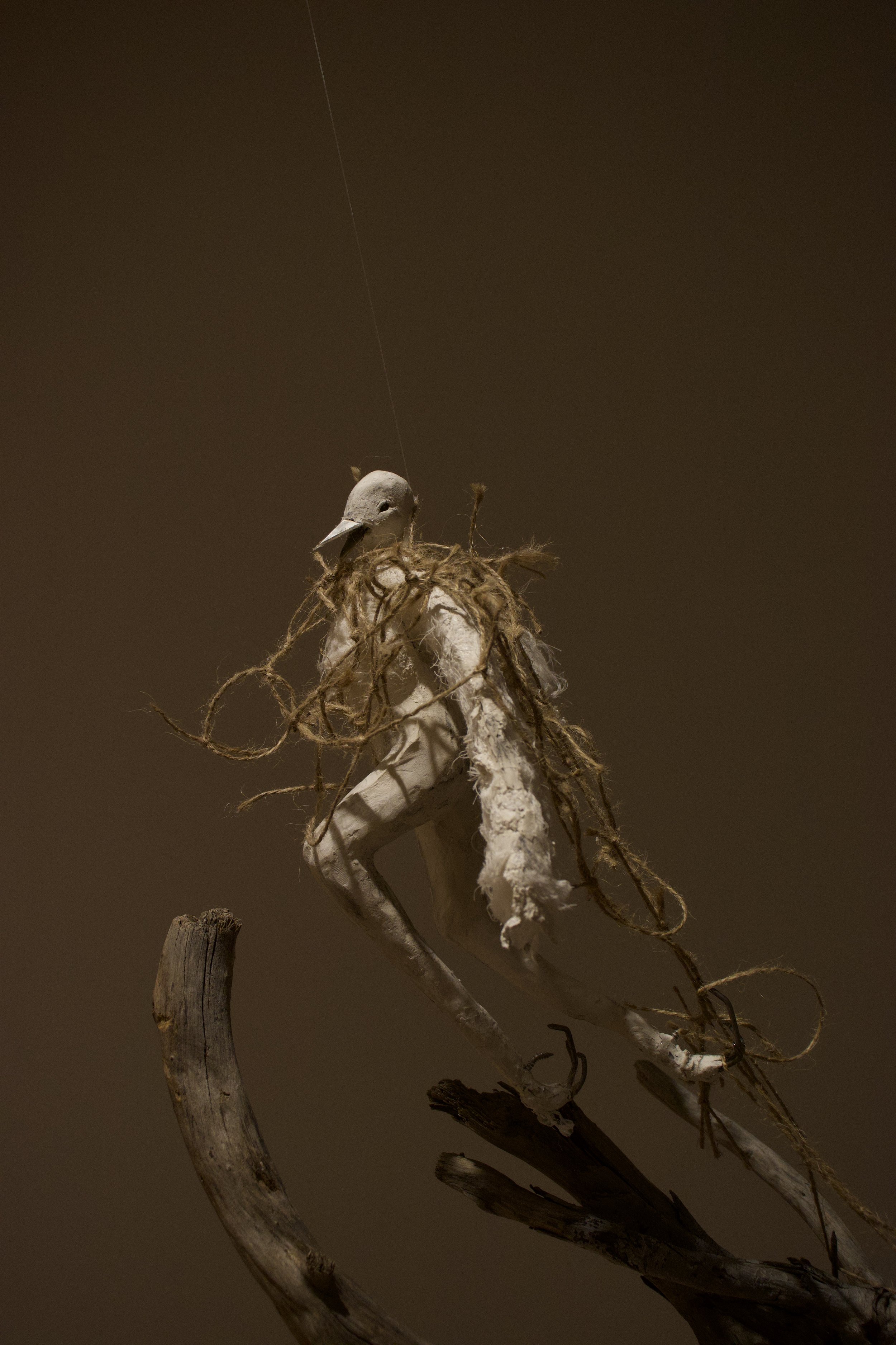 "The Crow" (2025) materials: aluminum wire, discarded plastic bags, yarn, cotton gauze, plaster, paper clay, mixed metals, charcoal