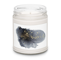 White scented candle in a glass jar with black and gold abstract design label