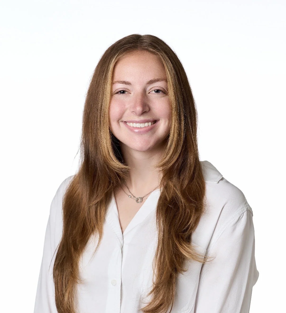 Image of a woman with long auburn hair wearing a white collared blouse