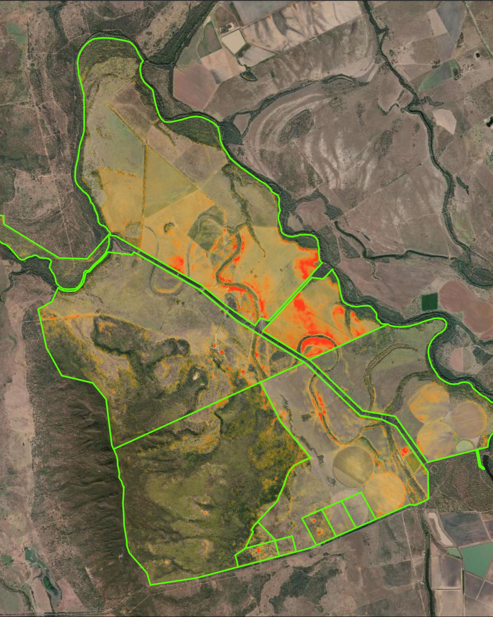A satellite map showing land divided into various zones outlined in green, with some areas colored in orange and red, indicating different land types or usage, with natural water bodies such as rivers visible in the surrounding landscape.