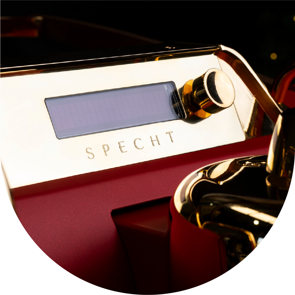 A cropped photograph of a red and gold Specht slayer espresso machine.
