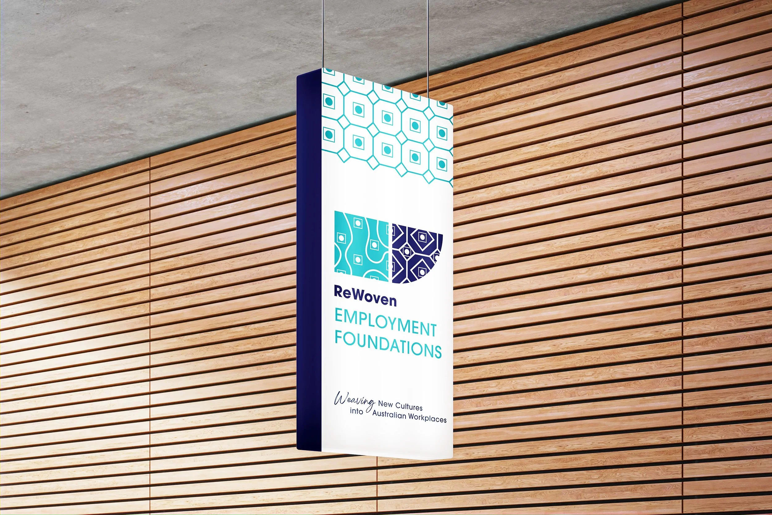 A hanging ReWoven Employment Foundations sign.