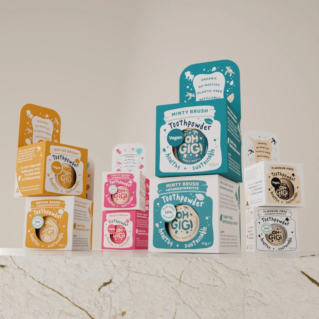 Eight ohGiGi toothpowder packaging boxes, stacked in set of two in matching flavours.