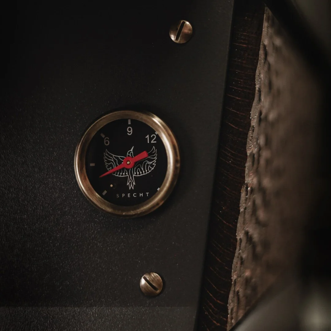 Close-up shot of a Specht espresso machine guage with the logo on it.